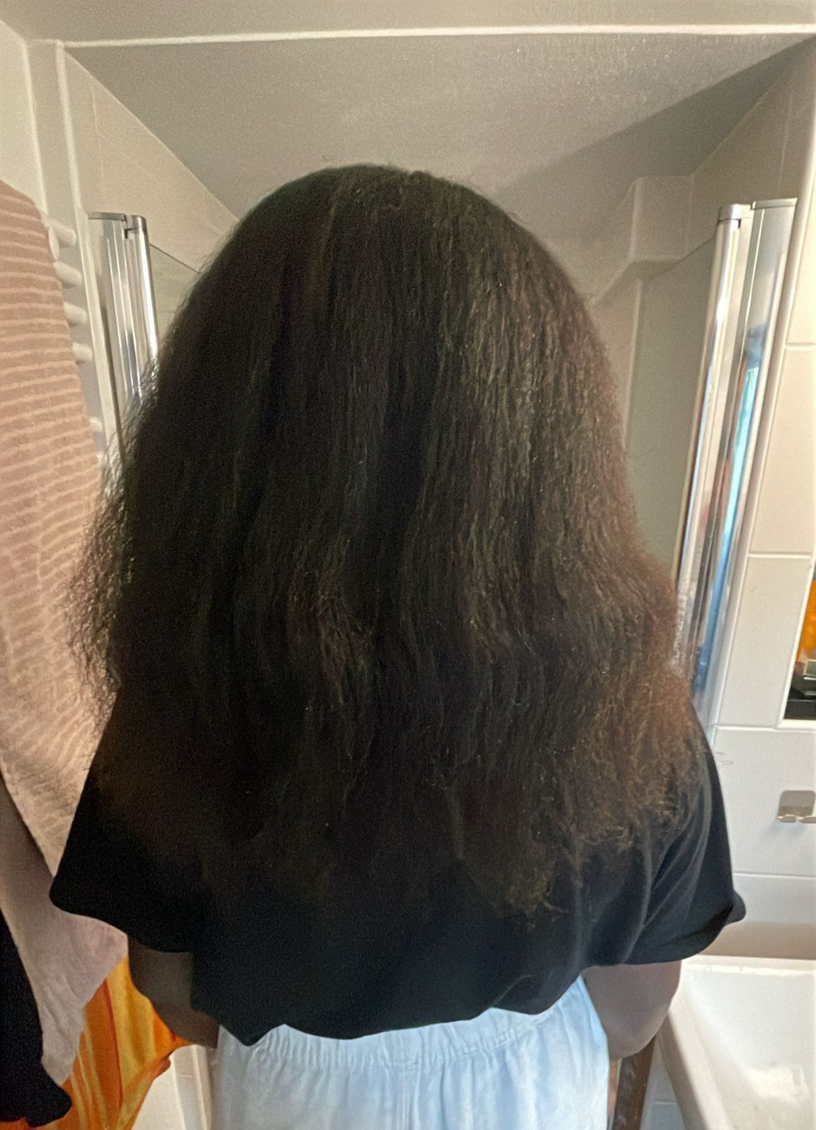 Soft, elongated, defined hair after one wash with the Nourish & Renew Hair Mask.